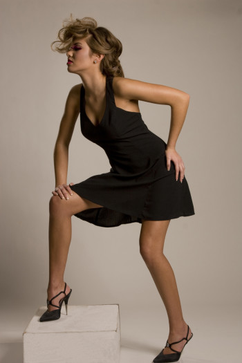 Carmen Maria modeling black dress and high heels