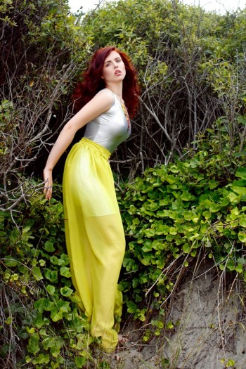 Ella Mokrushin wearing a long yellow skirt in a garden