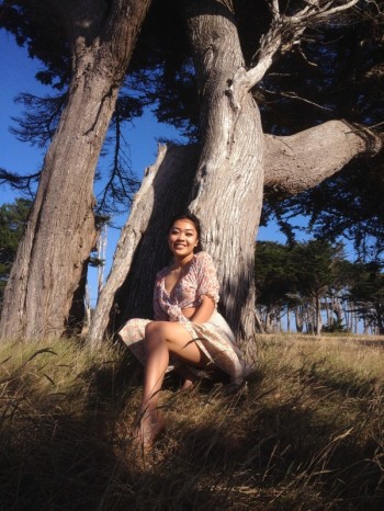 Gabriella Caylor next to a tree
