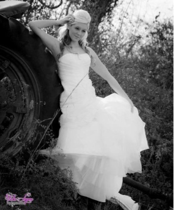 Red modeling a bridal dress in the countryside