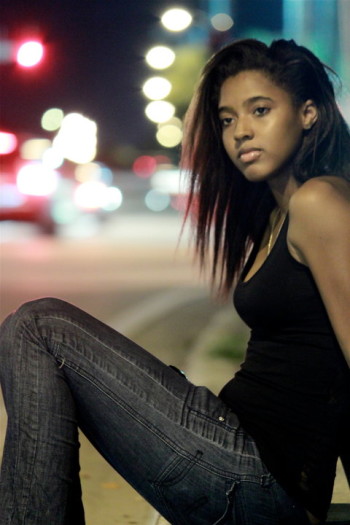 Sasha wearing black jeans in a street